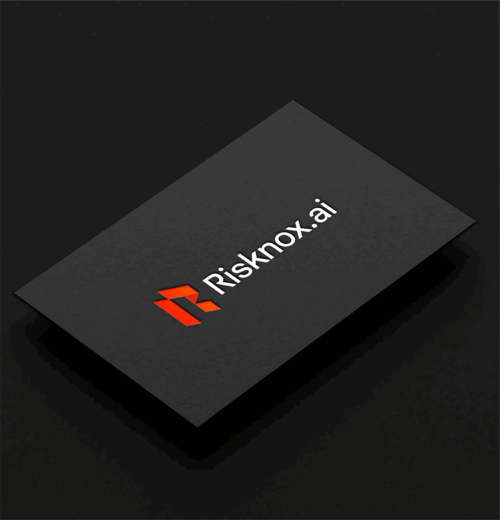 Risknox.ai logo embossed on a black business card
